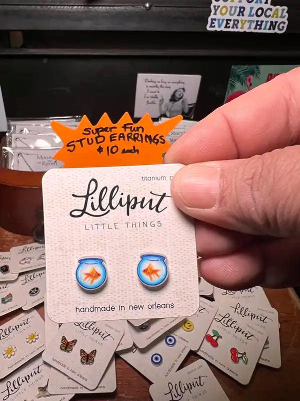 Fishbowl-style stud earrings with blue glass and a goldfish motif