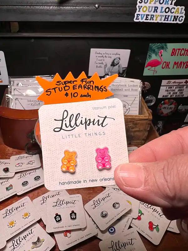 Novelty stud earrings with orange and pink gummy bear charms