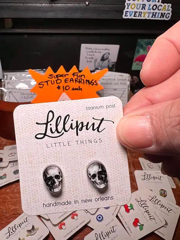 Novelty stud earrings with black skull face charms