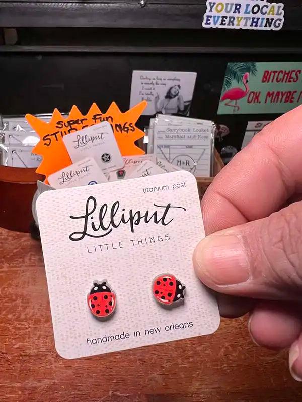 Novelty stud earrings with red ladybug charms
