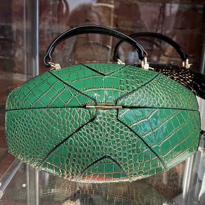 Close up shot of back of Eagles green football shaped purse on glass shelf