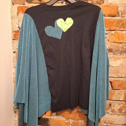 This picture shows the back of the grateful dead poncho with 2 colorful hearts sewn on . the front includes: Grateful Dead handmade poncho with turquoise ribbed winged arms. A rainbow of grateful dead dancing bears are stitched on to the front.