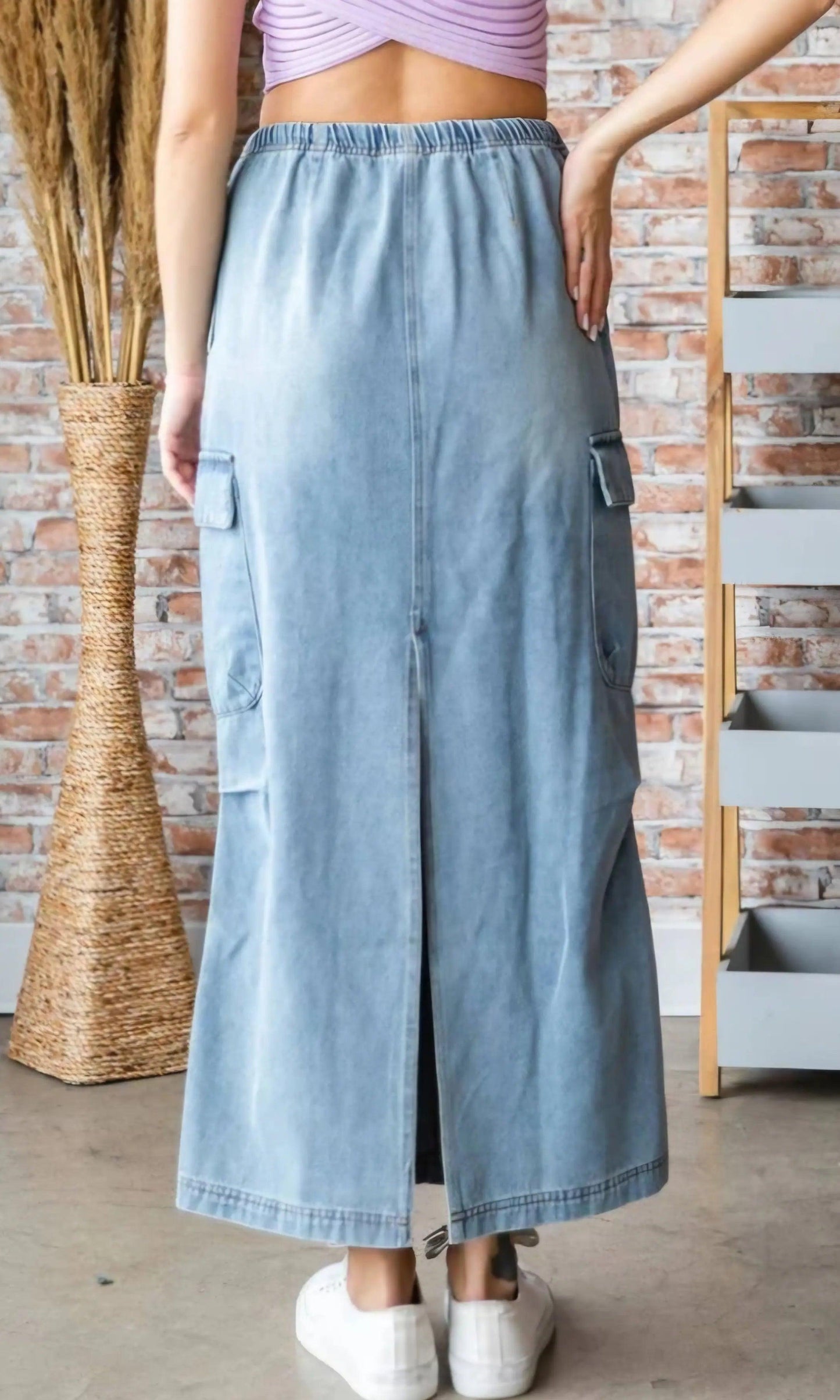 Back view of denim cargo maxi skirt showing back slit, cargo pockets, and elastic waistband — trendy maxi skirt with pockets
