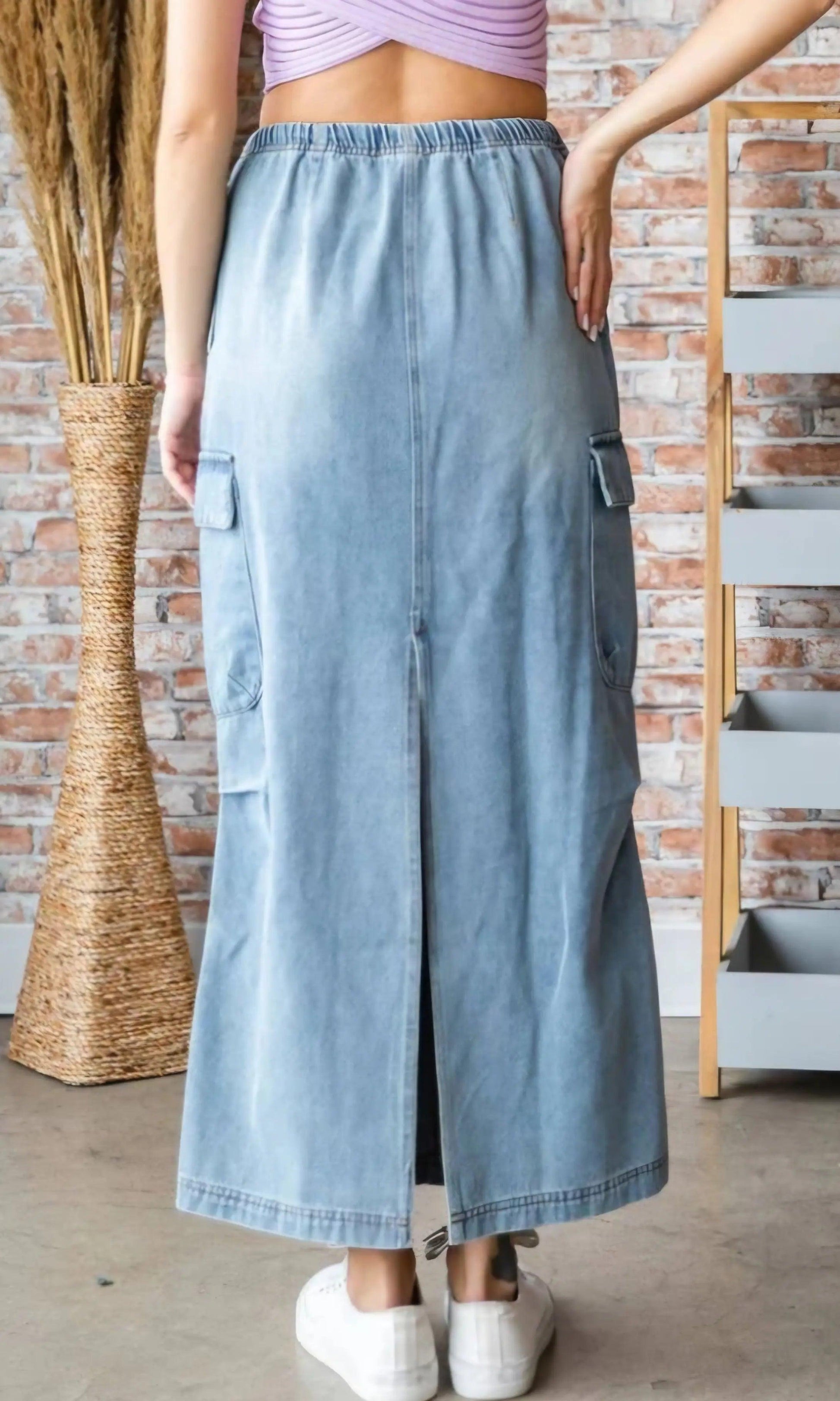 Back view of denim cargo maxi skirt showing back slit, cargo pockets, and elastic waistband — trendy maxi skirt with pockets