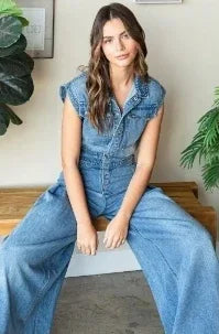Light wash wide leg denim jumpsuit with fitted waist and button down front, styled minimalist — coastal cowgirl utility fashion