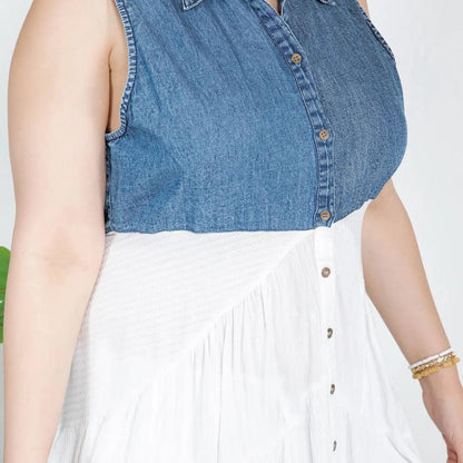 Person wearing a button down blue denim top and white skirt on a plain background