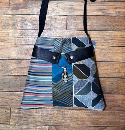 The Jackie Bag patchwork shoulder bag: blue stripes, black trim, snap belt closure
