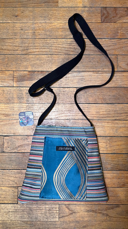 The Jackie Bag crossbody with blue geometric center panel and striped fabric sides