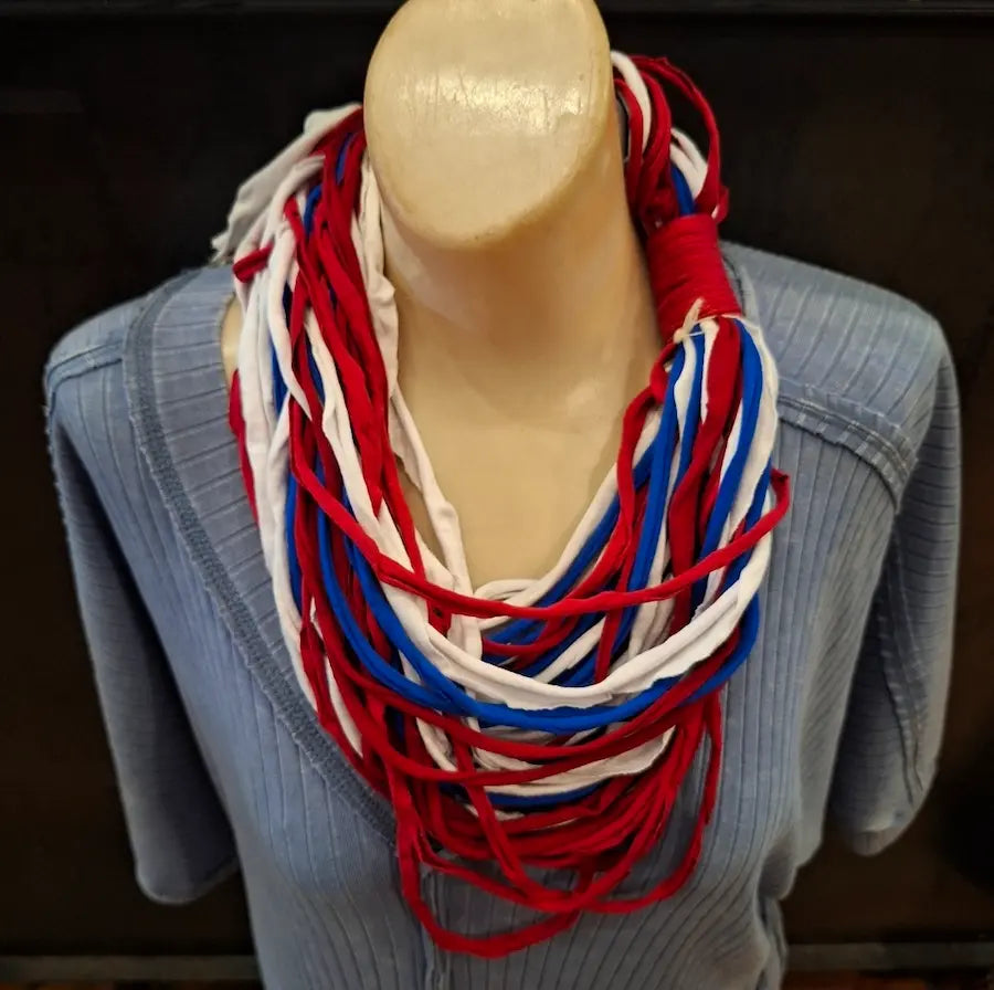 Mannequin wearing a red, white, and blue scarf for the Philadelphia Phillies team pride with a blurred background