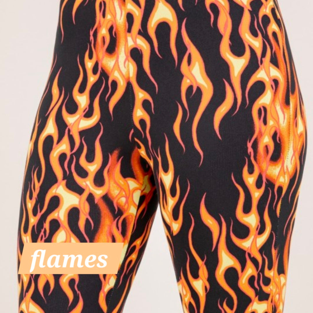 Flame print flare leggings with orange and yellow flames on a dark base