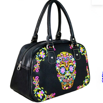 Black handbag with colorful skull and floral design on a white background