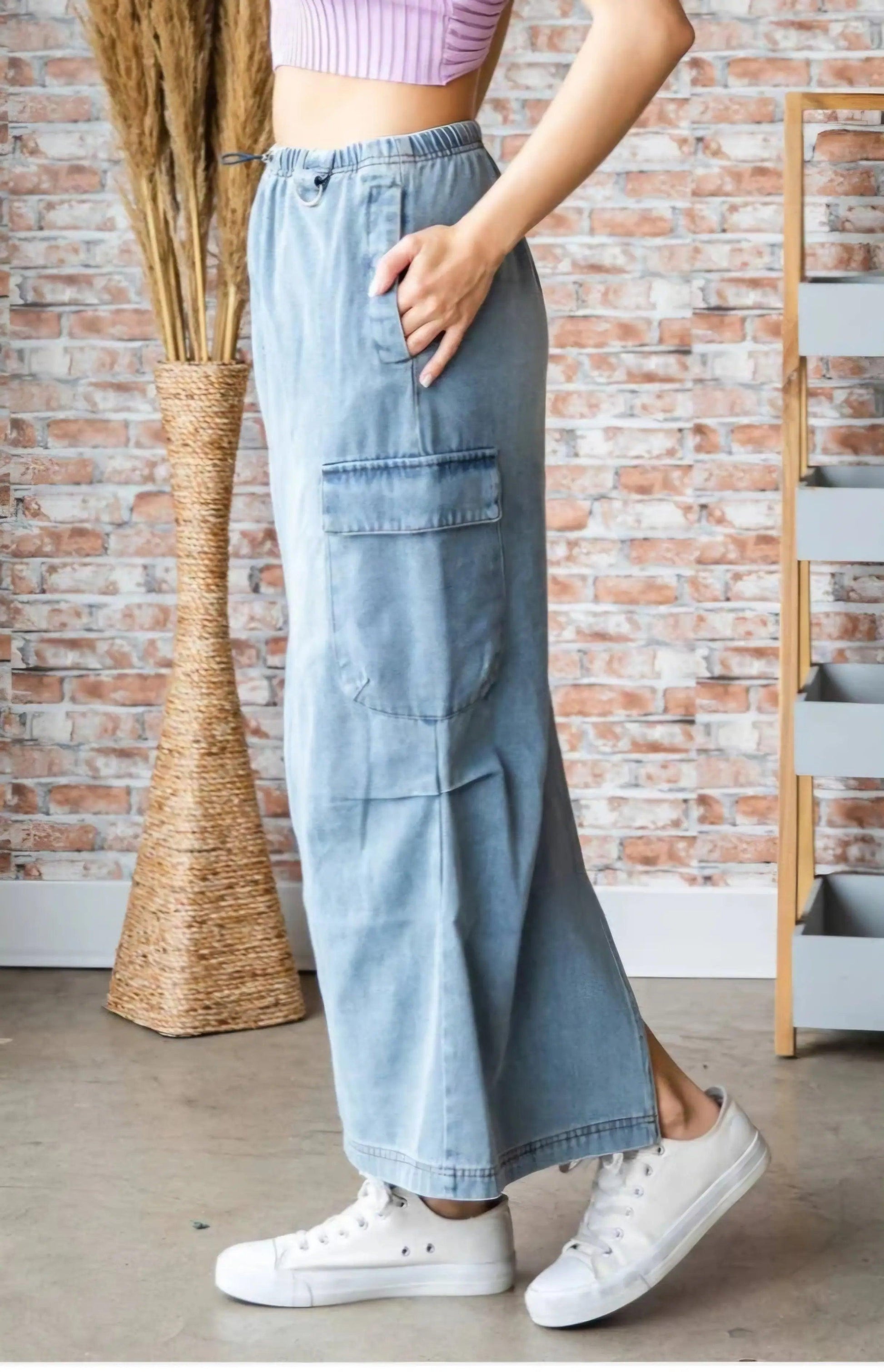Side view of light wash denim cargo maxi skirt showing functional cargo pocket and drawstring elastic waist — boho chic utility skirt