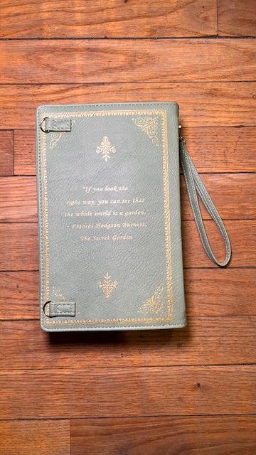Gray leather-bound  Peter Pan book with gold text on a wooden surface